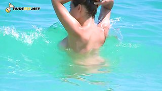 Smoothest nudist play in the warm water at a nudist beach