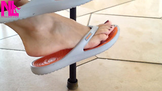 Dangling with Orange Flip Flops in a Swimming Pool