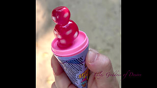 Innocent Girl Sits in the Park and Eats Lollipop Not Knowing That Her Panties Can Be Seen