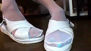 Ravishing Oriental girl in pantyhose flaunts her sexy feet
