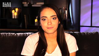 In a kitchen a sexy brunette playing with her big boobs