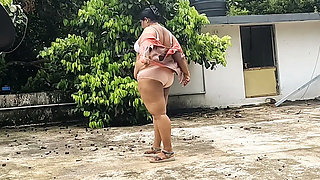 A Full-figured Woman in a White Skirt and Pink Top Strips Down and Walks Nude Outside
