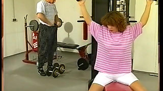 Lovely milf is riding a ripped guy's cock in the gym